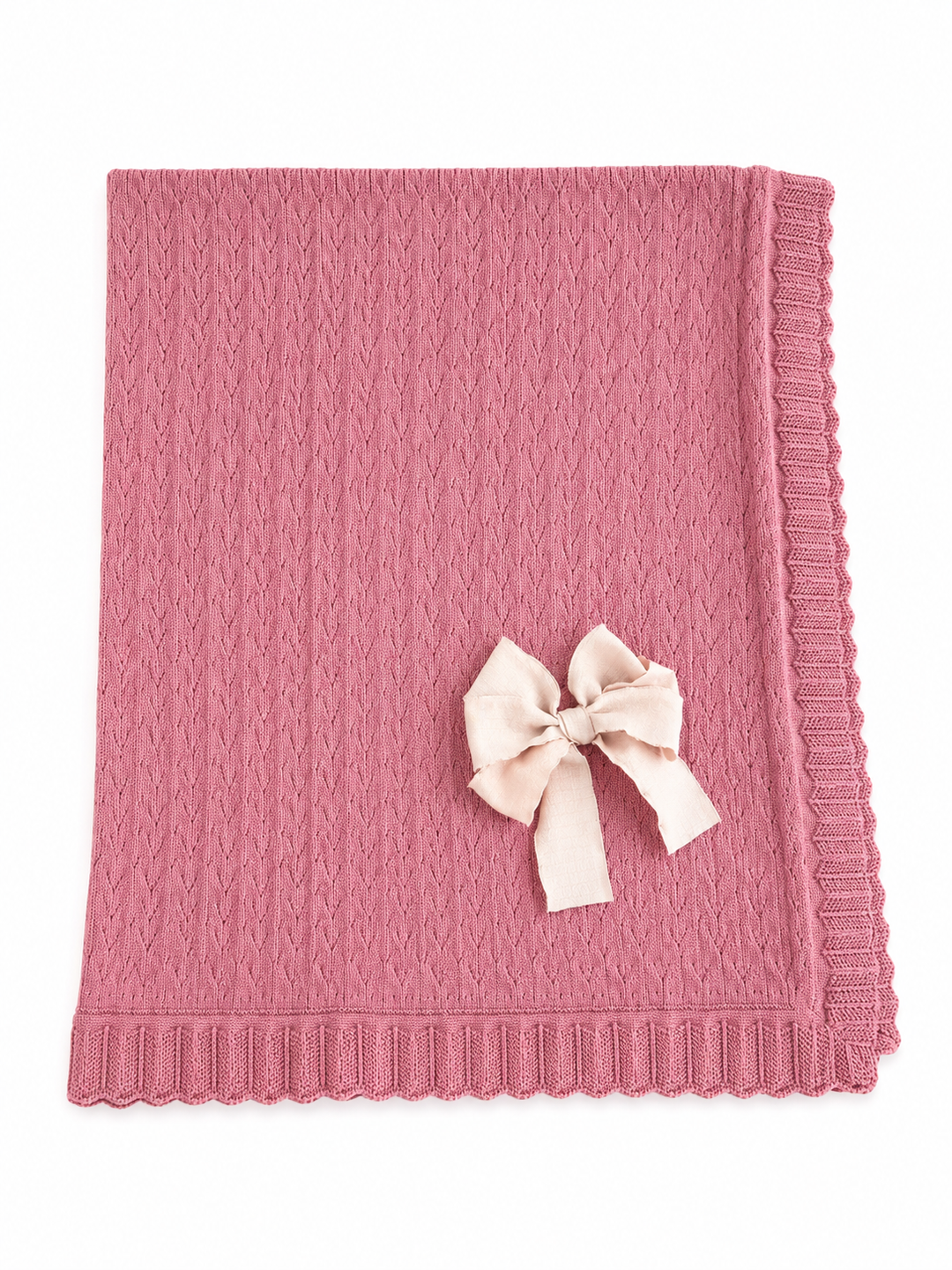 Cobija de punto rosa con moño beige